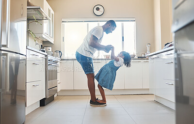 Buy stock photo Dad, daughter and dancing in home, holding hands and support with movement practice in kitchen. Father, girl and trust parent in relationship for ballet performance, love and together for learning