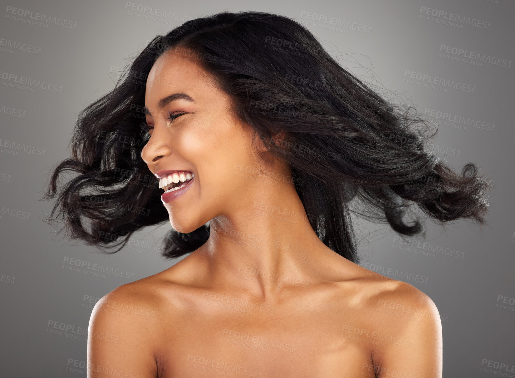 Buy stock photo Cropped shot of an attractive young woman posing in studio against a grey background