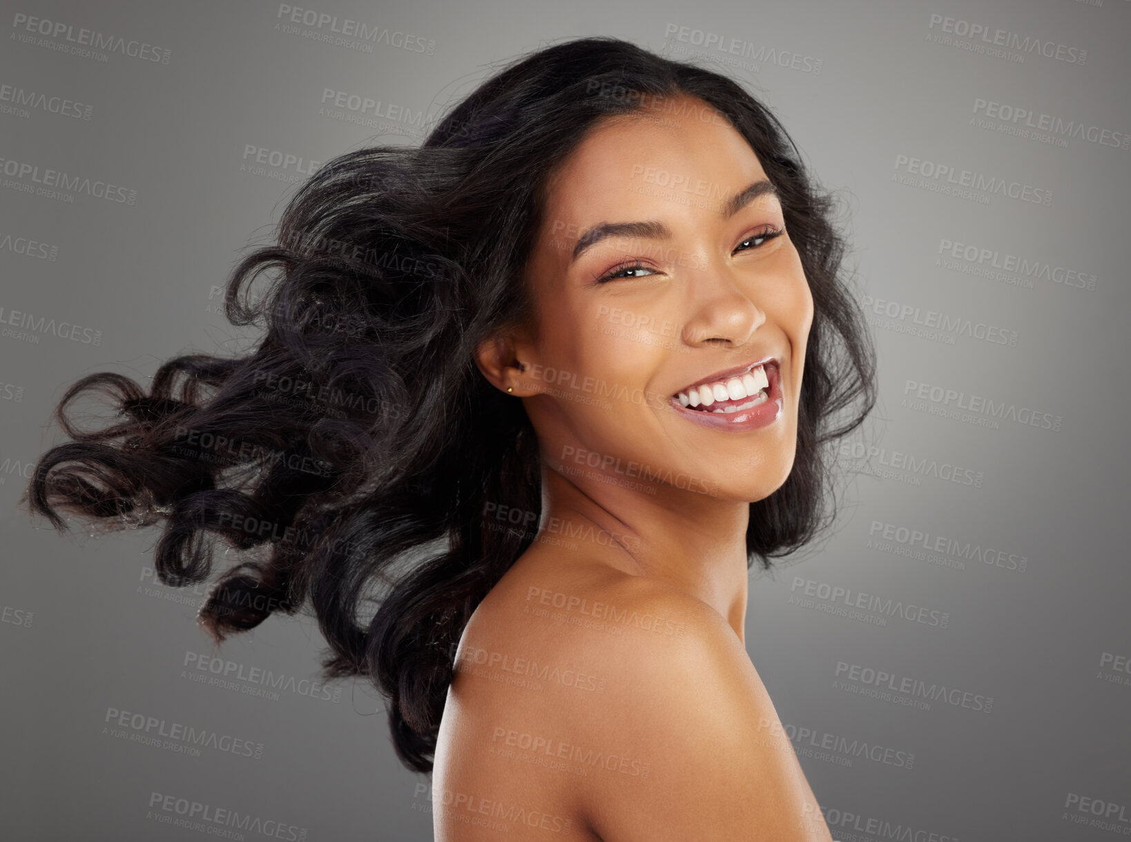 Buy stock photo Happy, hair and portrait of woman in studio smile for confidence, healthy texture and growth. Salon, hairdresser and isolated person with wind for beauty, wellness and cosmetics on gray background