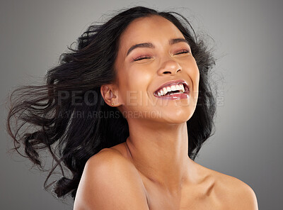 Buy stock photo Happy, hair and woman in studio with wind for confidence, healthy texture and growth. Salon, hairdresser and face of isolated person laugh for beauty, wellness and cosmetics on gray background