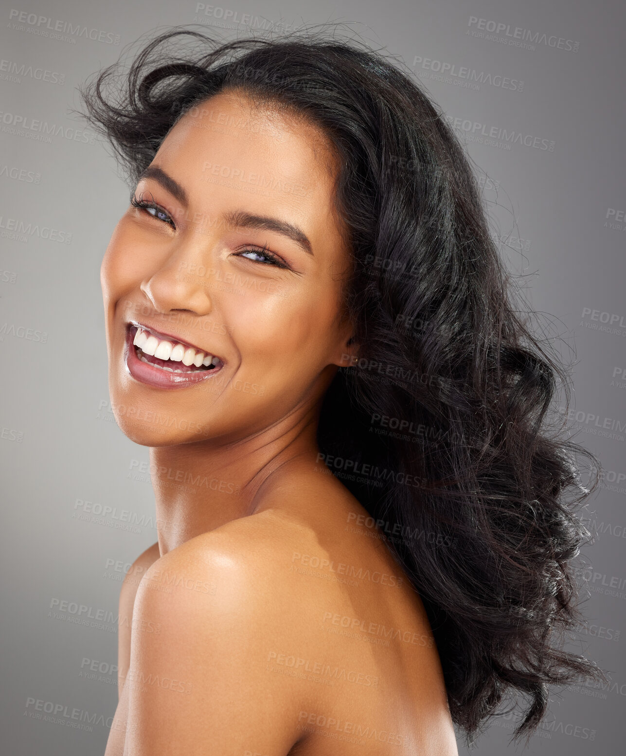 Buy stock photo Cropped portrait of an attractive young woman posing in studio against a grey background