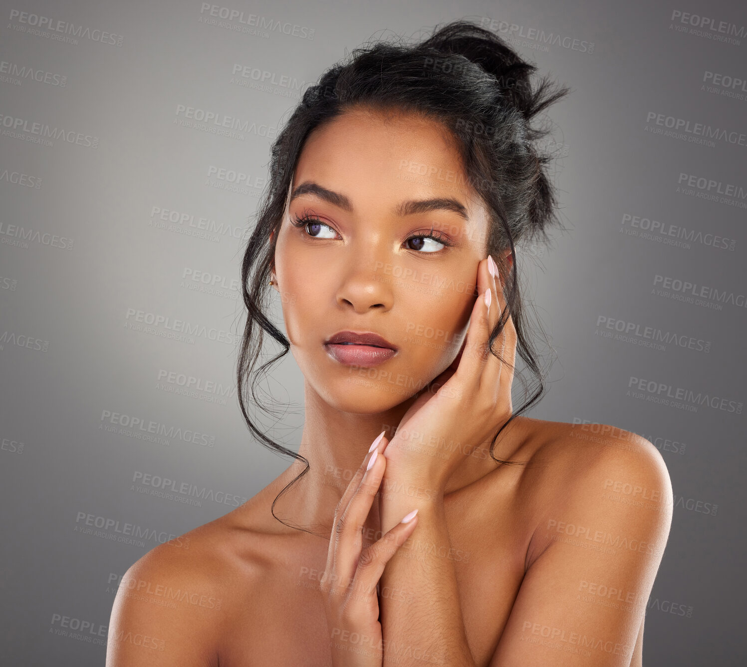 Buy stock photo Cropped shot of an attractive young woman posing in studio against a grey background