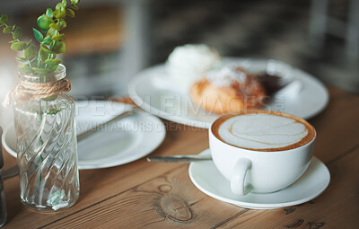 Buy stock photo Coffee shop, morning and cappuccino at table with food, pastry and breakfast at cafe with minimalist decor. Venue, plate and afternoon tea with latte, mug and cream with hot drink and French diner