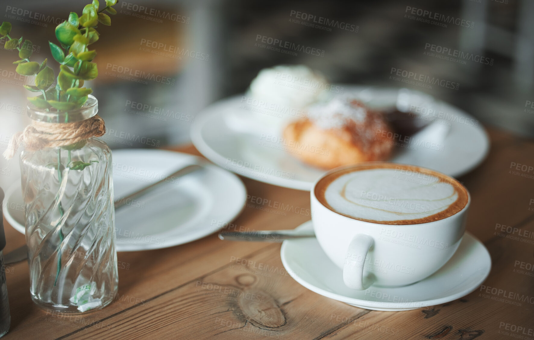 Buy stock photo Coffee shop, morning and cappuccino at table with food, pastry and breakfast at cafe with minimalist decor. Venue, plate and afternoon tea with latte, mug and cream with hot drink and French diner