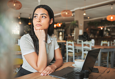 Buy stock photo Shot of a young woman day dreaming while working in a cafe