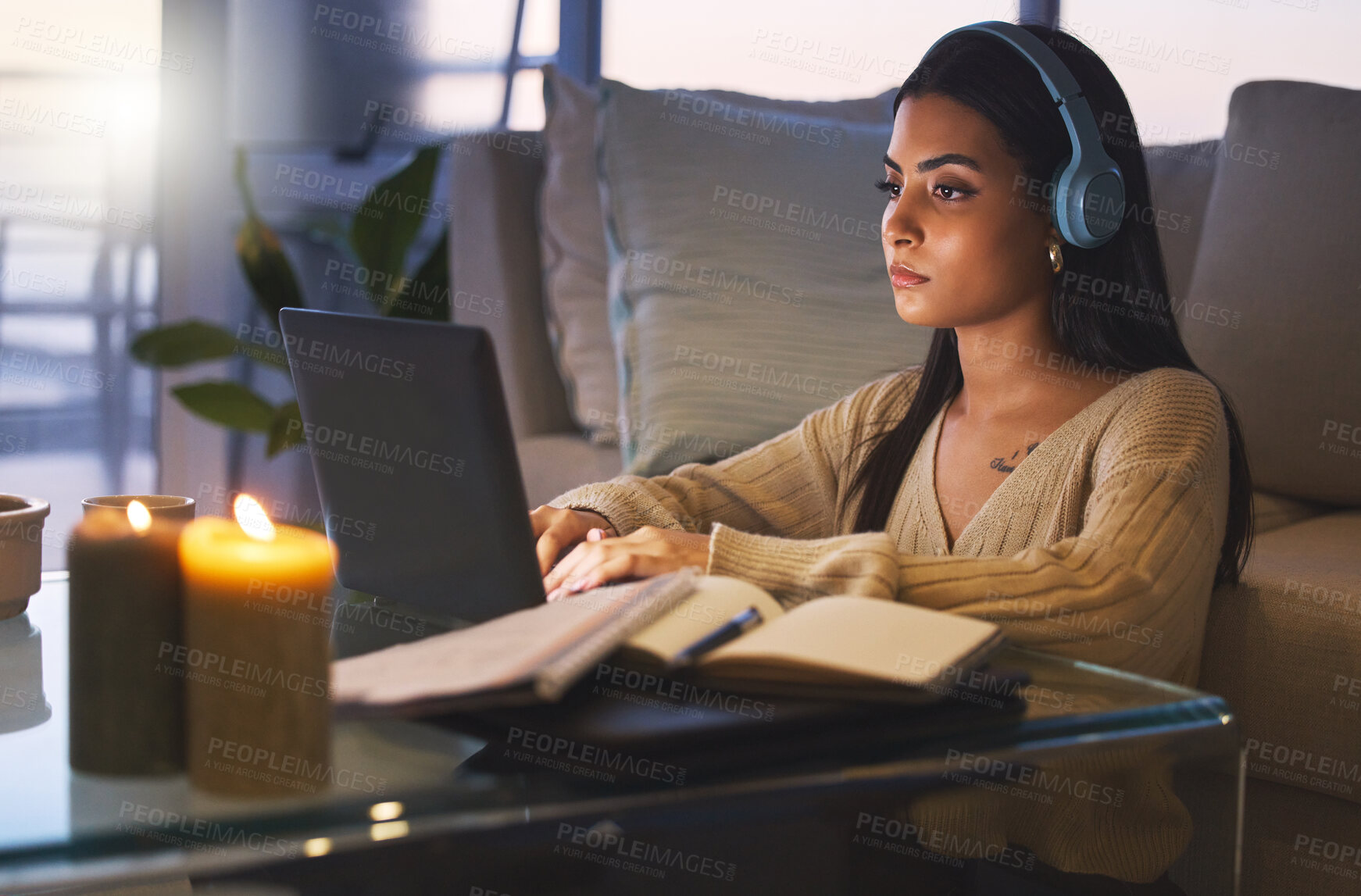 Buy stock photo Laptop, online course and woman on sofa with headphones, books and virtual university project at night. Elearning education, research and college student with computer, webinar and studying at home