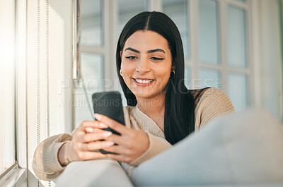 Buy stock photo Happy, typing and woman with phone on sofa for social media, online chat and website in home. Relax, smile and girl on smartphone for communication, contact and internet in living room on weekend