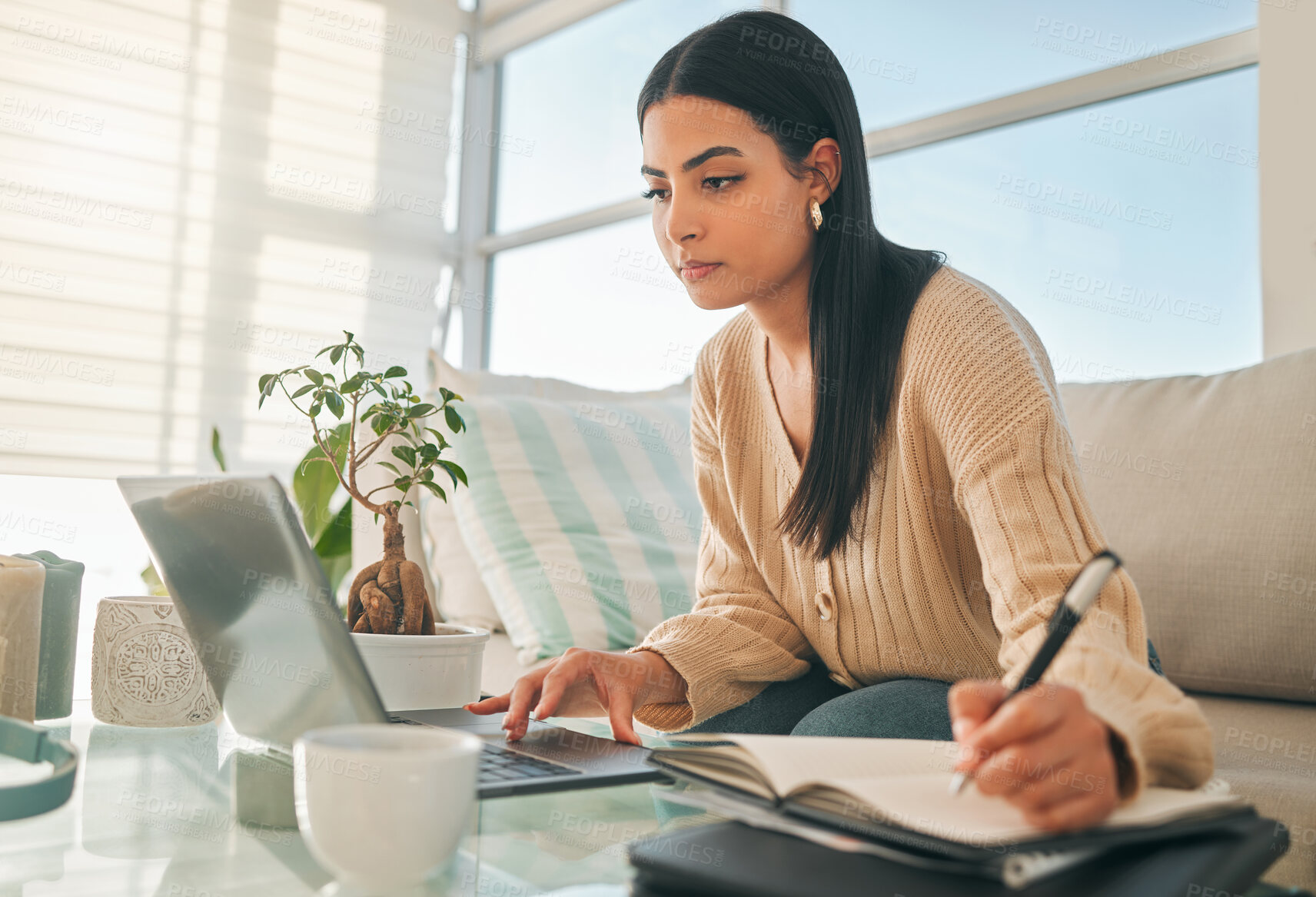 Buy stock photo Woman, laptop and writing in notebook at home with studying, elearning and online university essay. Research, education and notes with internet, diary and planning for exam with web planner on couch