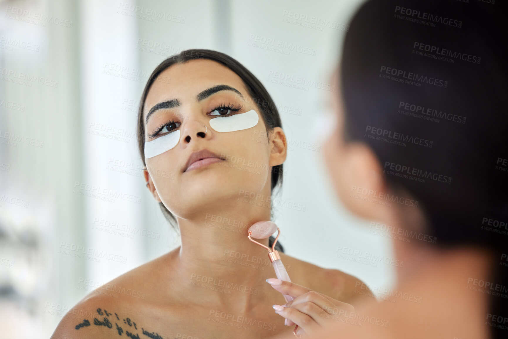 Buy stock photo Woman, rose quarts and eye patches at bathroom on mirror for skincare, beauty and glow with self care. Female person, apartment and stone for fresh skin, grooming and facial treatment or routine