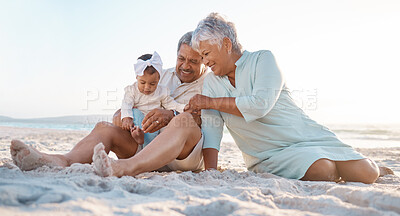 Buy stock photo Shot of a senior couple at the beach with their adorable granddaughter