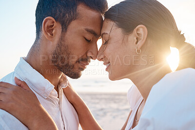 Buy stock photo Shot of a young couple spending time together at the beach