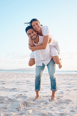 Buy stock photo Shot of a young couple spending time together at the beach