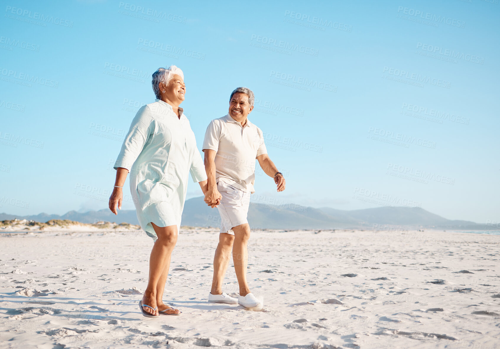 Buy stock photo Shot of a mature couple spending time together at the beach