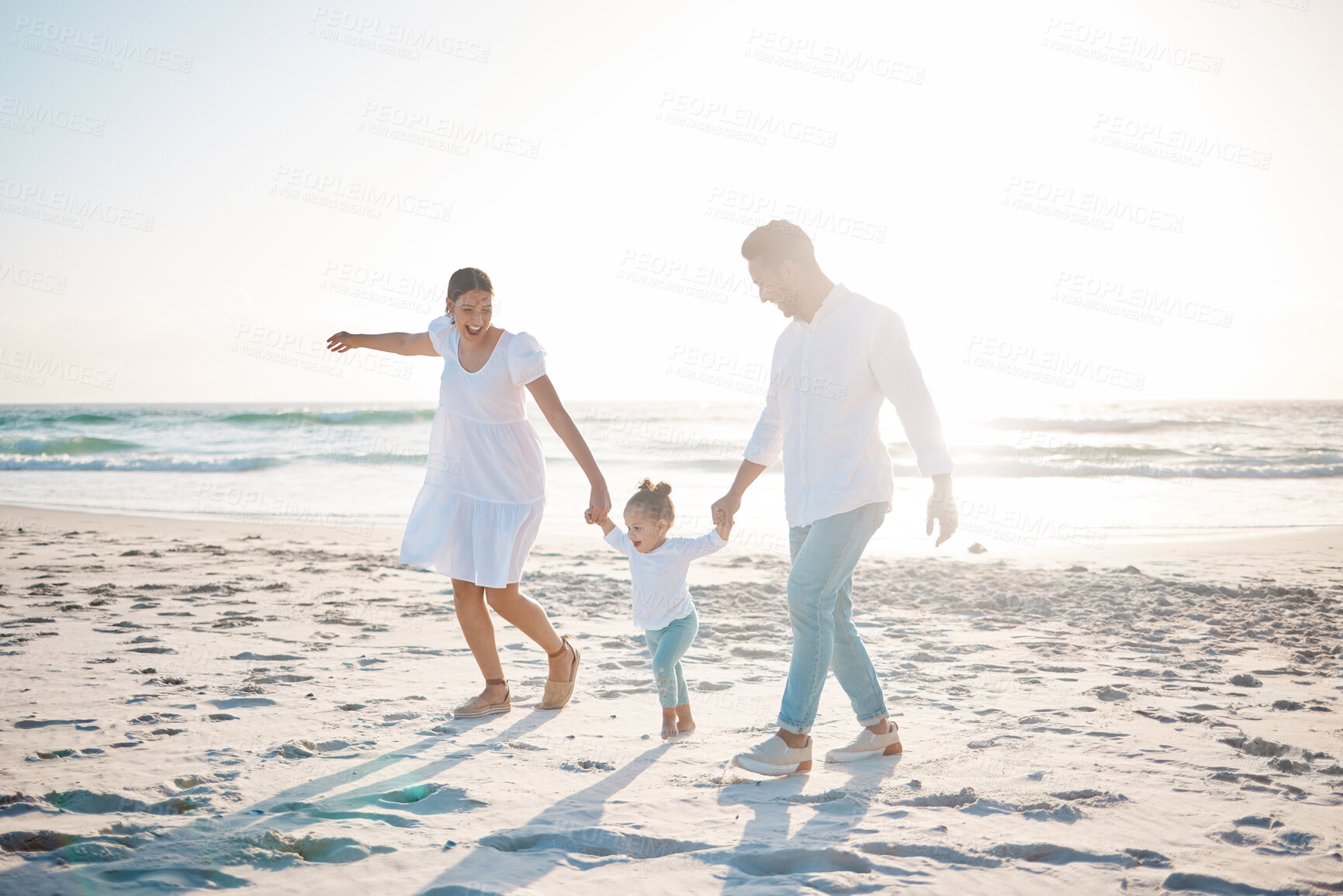 Buy stock photo Happy family, holding hands and playing on beach with mockup space for holiday weekend or vacation. Mother, father and child enjoying play time together on ocean coast for fun bonding in nature