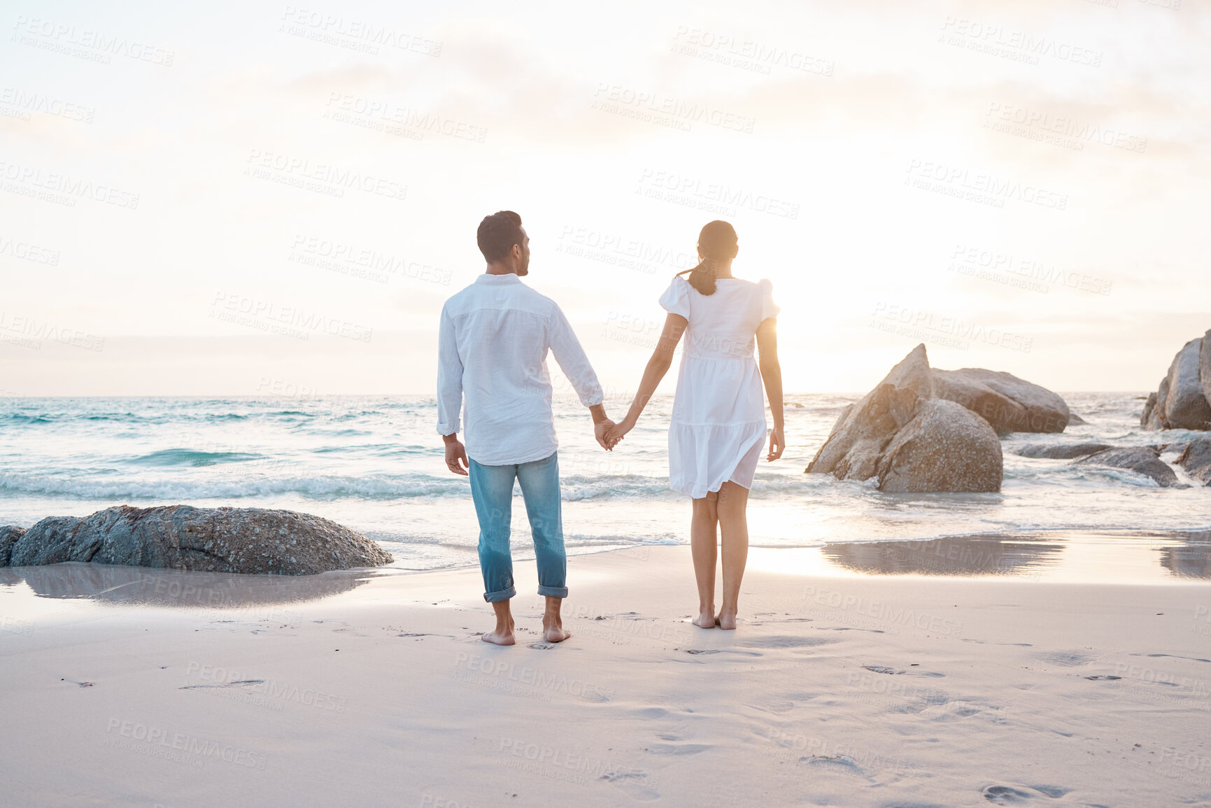 Buy stock photo Couple, holding hands and back at sunset, beach and love with bonding for memory in summer by waves. People, woman and man with care, connection and loyalty on holiday together by ocean in Indonesia