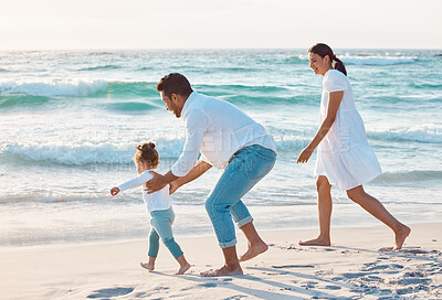 Buy stock photo Shot of a couple spending the day at the beach with their daughter