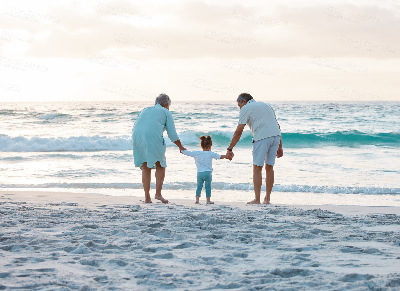 Buy stock photo Shot of a couple spending the day at the beach with their daughter