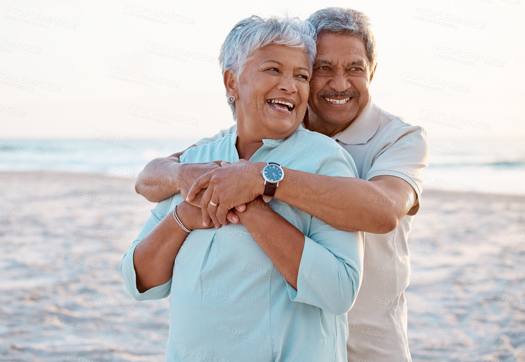 Buy stock photo Shot of a mature couple spending time together at the beach