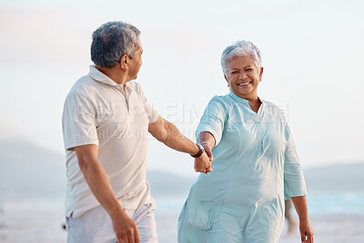 Buy stock photo Shot of a mature couple spending time together at the beach