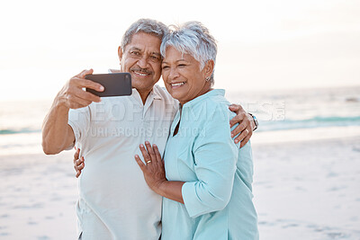 Buy stock photo Senior couple, hug and beach for selfie, profile picture or online post together in nature. Happy elderly man and woman smiling on ocean coast for photo, memory or social media vlog in the outdoors