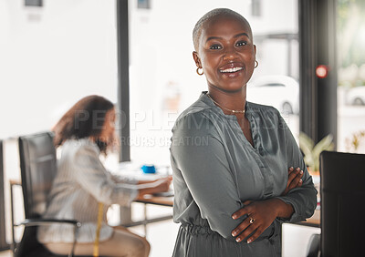 Buy stock photo Shot of a young businesswoman standing with her arms crossed at work