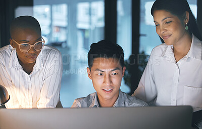 Buy stock photo Shot of a group of businesspeople working late in a modern office