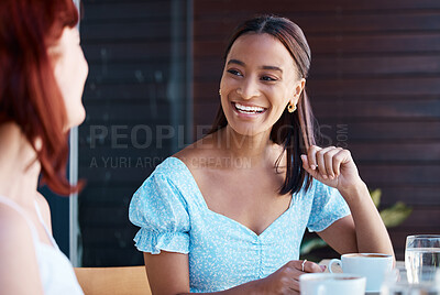 Buy stock photo Shot of two young female friends catching up at a cafe