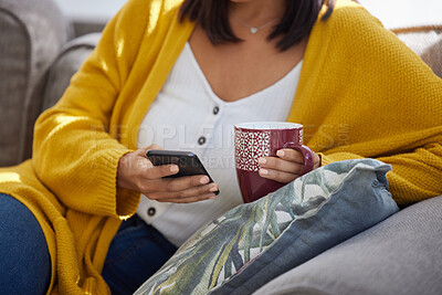 Buy stock photo Shot of an unrecognizable person using a phone at home