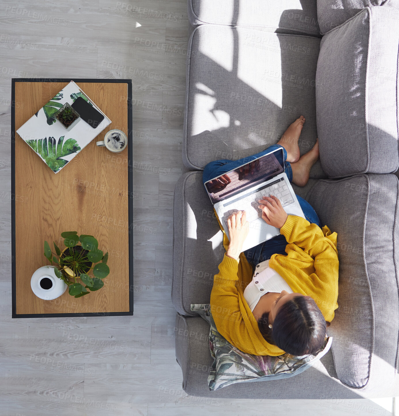 Buy stock photo Shot of a young woman using a laptop at home