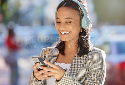 Buy stock photo Cropped shot of an attractive young woman checking her messages while out on the town