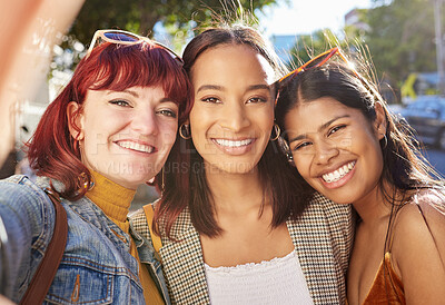 Buy stock photo Cropped portrait of three attractive young girlfriends taking selfies while out on the town