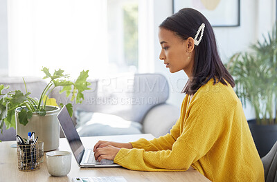 Buy stock photo Shot of a young businesswoman using a laptop in a modern office at work