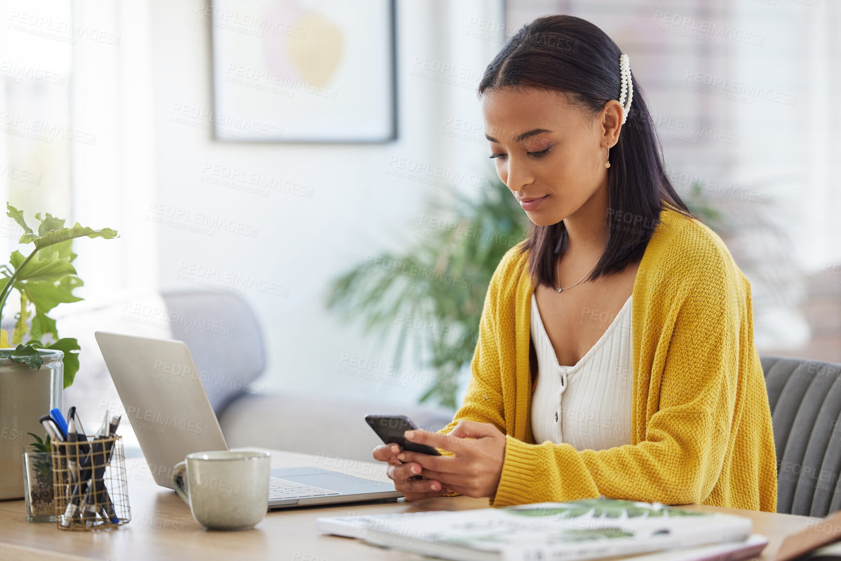 Buy stock photo Shot of a young businesswoman using a phone in a modern office at work