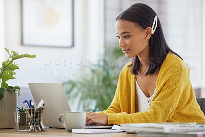 Buy stock photo Shot of a young businesswoman using a laptop in a modern office at work