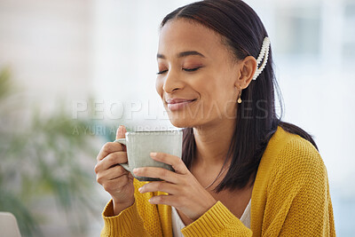 Buy stock photo Shot of a young woman drinking coffee at home