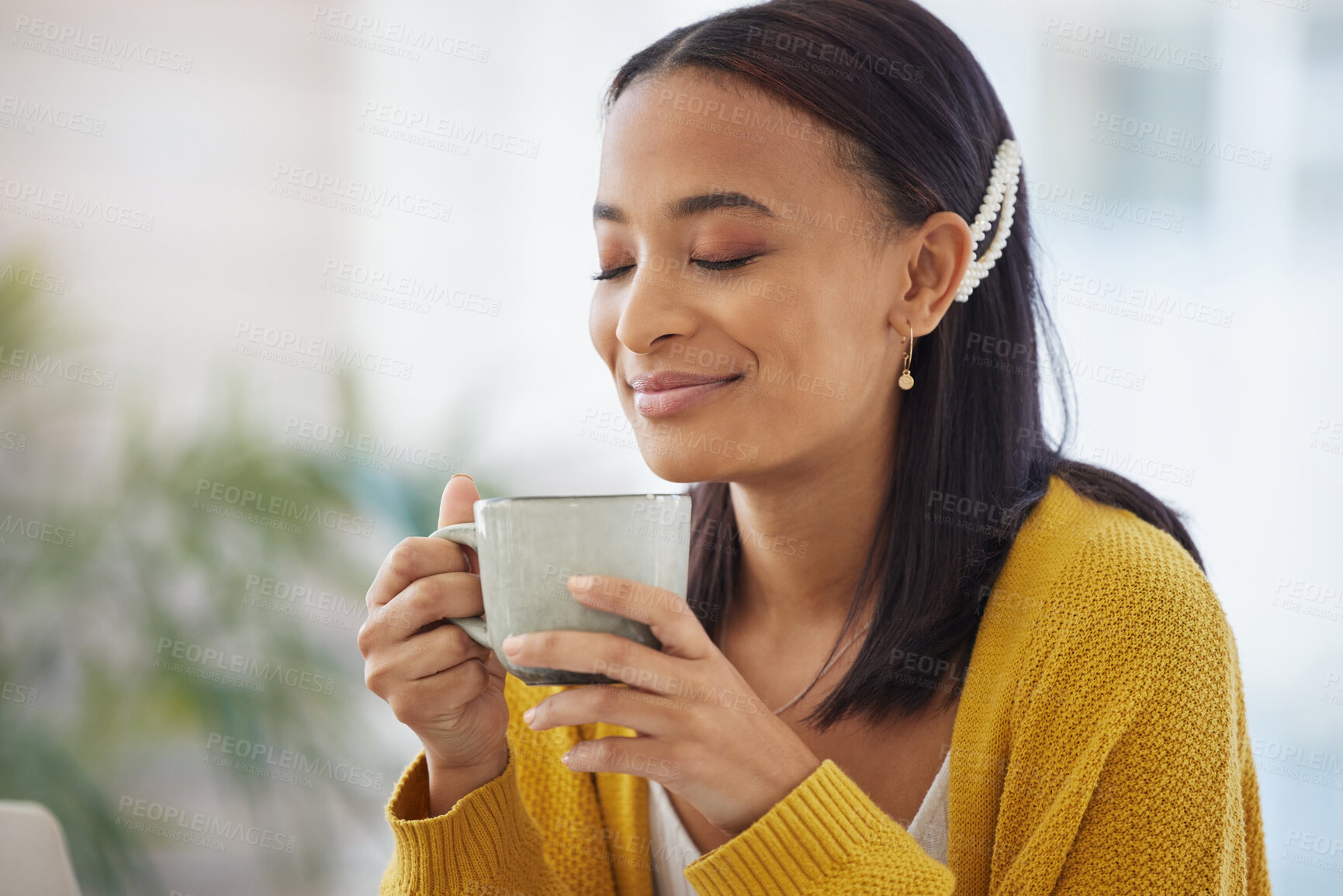 Buy stock photo Shot of a young woman drinking coffee at home