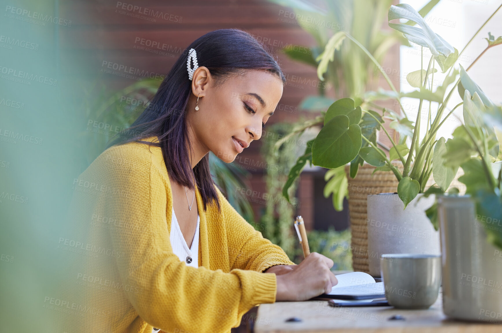 Buy stock photo Shot of a young businesswoman working on the balcony at home