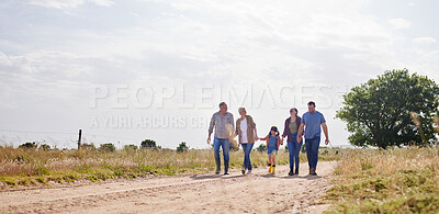 Buy stock photo Shot of a multi-generational family walking together on a farm