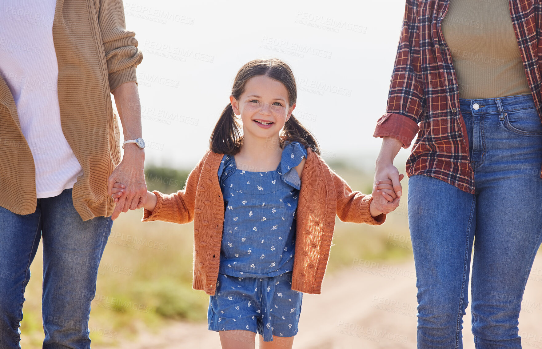 Buy stock photo Shot of a little girl walking on a farm with her family