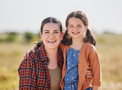 Buy stock photo Shot of a woman and her daughter spending time outside on their farm