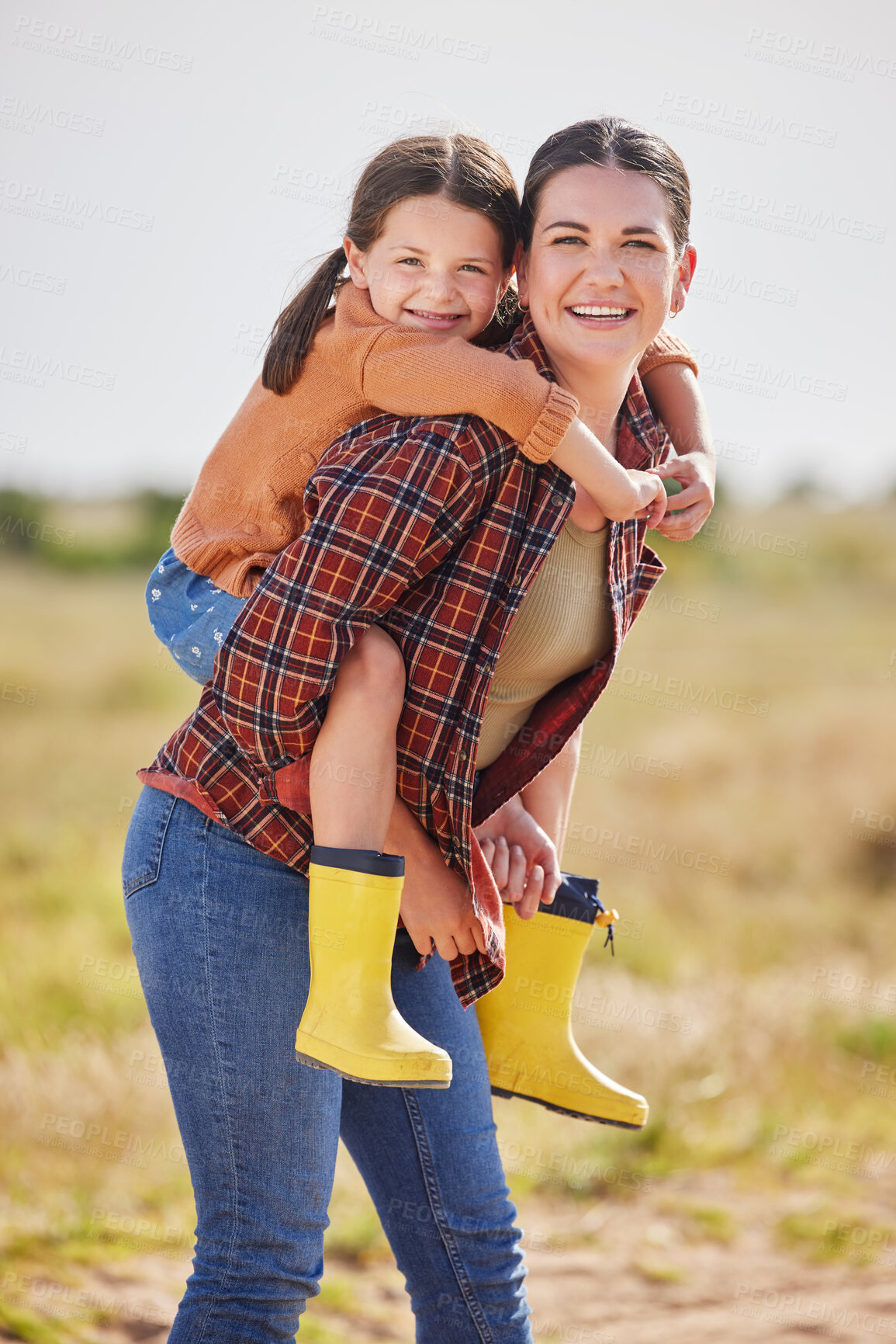 Buy stock photo Shot of a woman and her daughter spending time outside on their farm