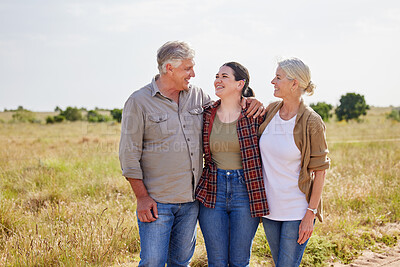 Buy stock photo Shot of a young woman on a farm with her senior parents