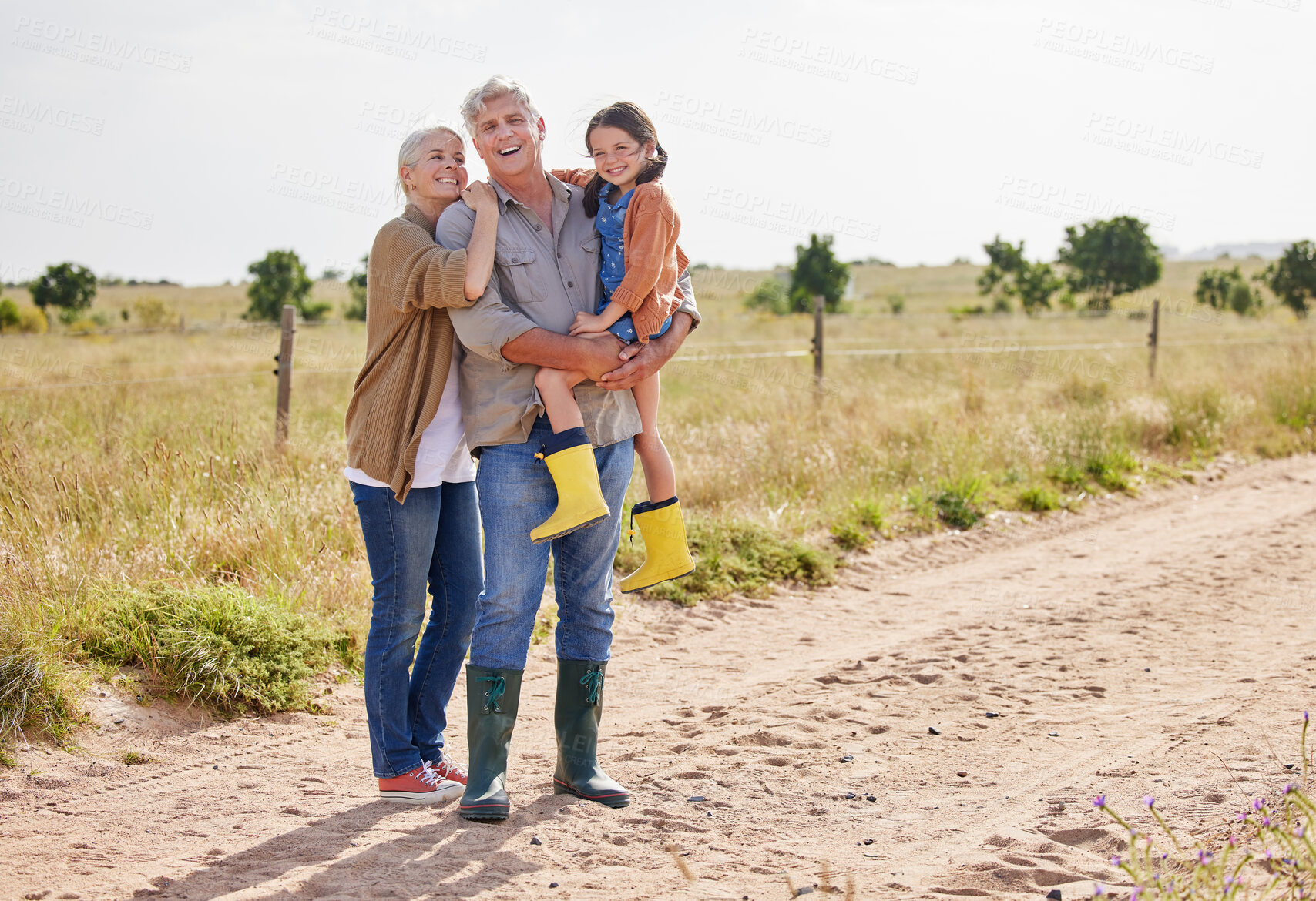 Buy stock photo Farm, grandparents and child with smile in portrait, sustainable environment and bonding together. Laugh, grandmother or grandfather with girl in countryside, agriculture or carrying with hug outdoor