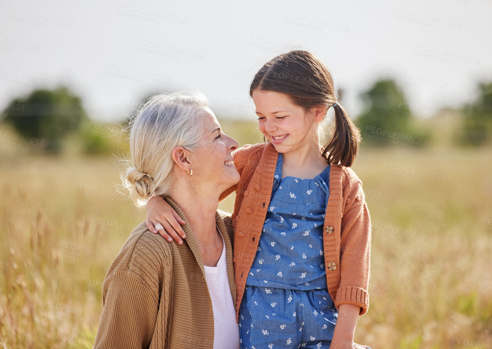 Buy stock photo Shot of an adorable little girl on a farm with her grandmother