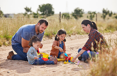 Buy stock photo Shot of two little girls playing together on a farm with their parents