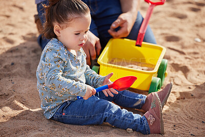 Buy stock photo Shot of an adorable little girl playing in the sand