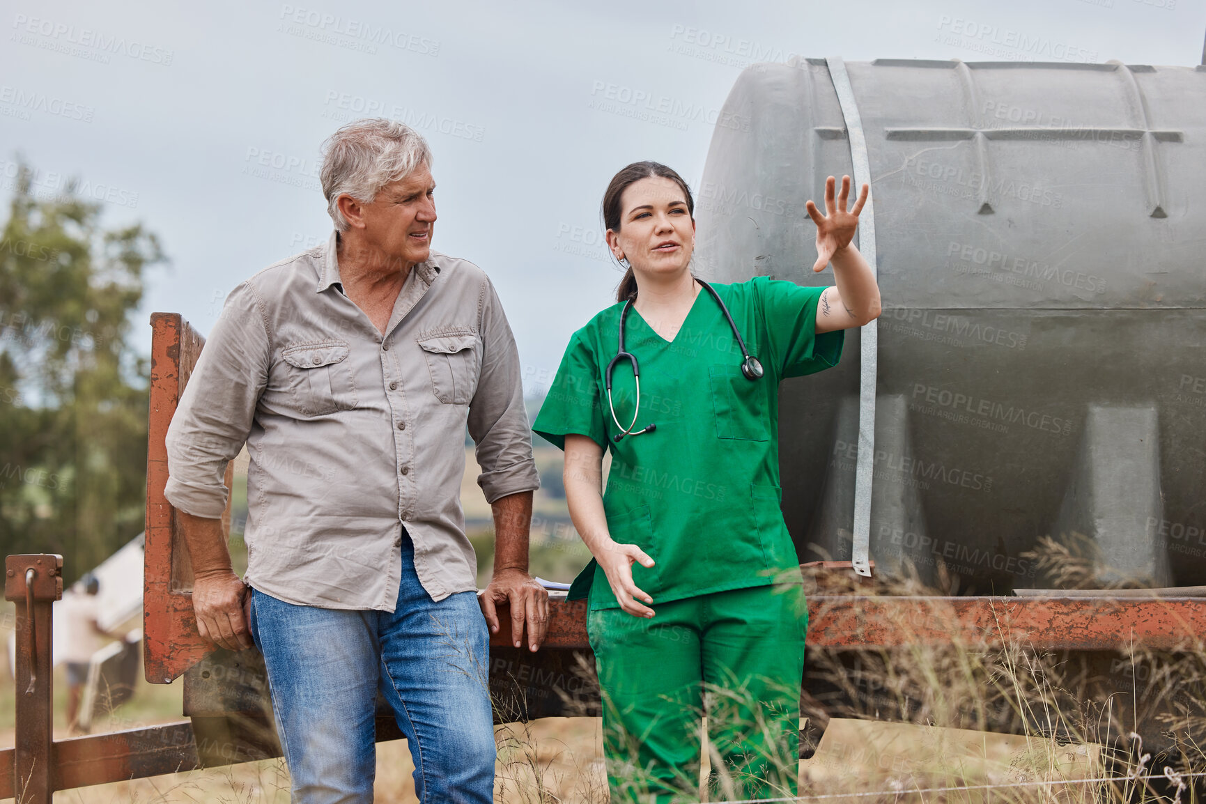 Buy stock photo Shot of a veterinarian talking to a mature man on his farm