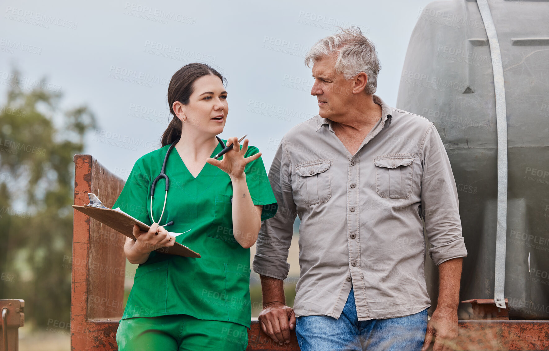 Buy stock photo Shot of a veterinarian talking to a mature man on his farm