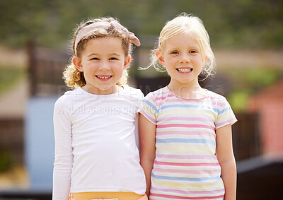 Buy stock photo Shot of two little girls standing together outside