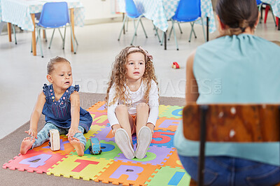Buy stock photo Shot of two little girls sitting next to each other in class